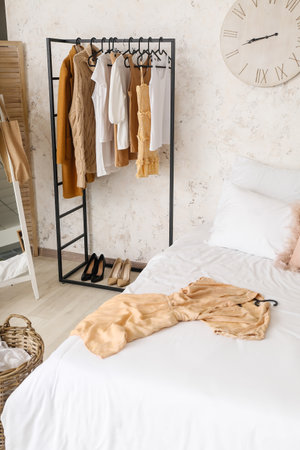 Interior of stylish bedroom with clothes rackの写真素材