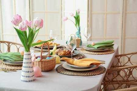 Festive table served for Easter celebration in dining roomの写真素材