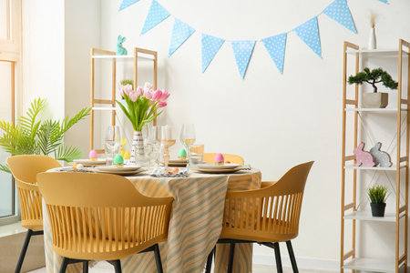 Interior of dining room with table served for Easter celebration
