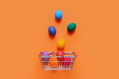 Shopping basket and Easter eggs on orange backgroundの写真素材