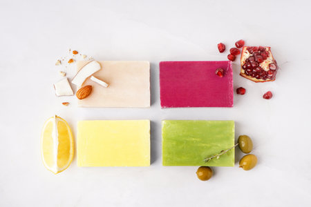 Composition with soap bars and natural ingredients on light background