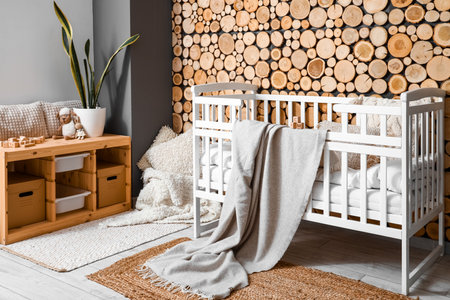Interior of children's bedroom with baby crib and shelving unitの写真素材