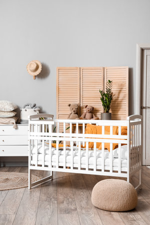 Interior of children's bedroom with baby crib and commodeの写真素材