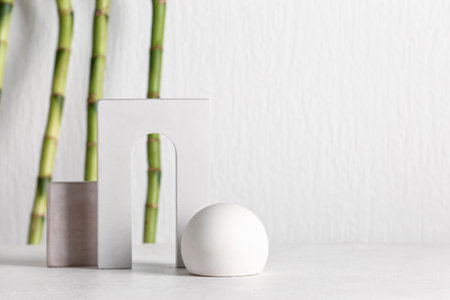 Green bamboo stems and plaster podiums on white backgroundの写真素材