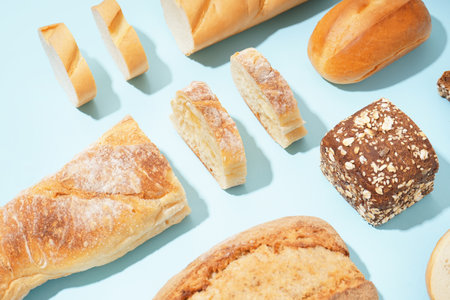 Fresh loaves of different bread on blue backgroundの写真素材