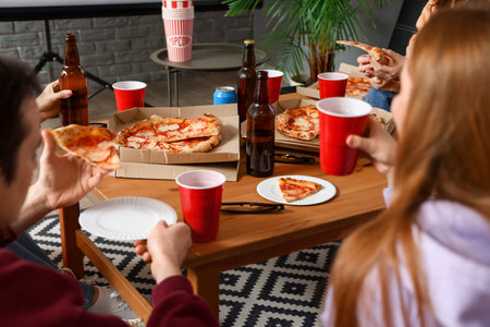 Group of friends with tasty pizza and drinks at home, closeupの写真素材