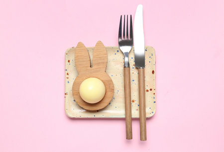 Table setting with Easter egg on pink backgroundの写真素材