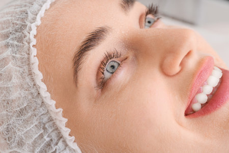Woman undergoing cosmetic procedure in beauty salon, closeupの写真素材