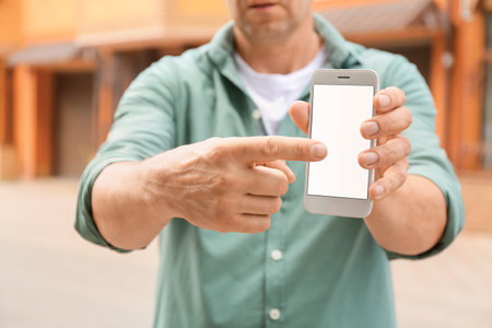 Man using smart phone outdoorsの写真素材