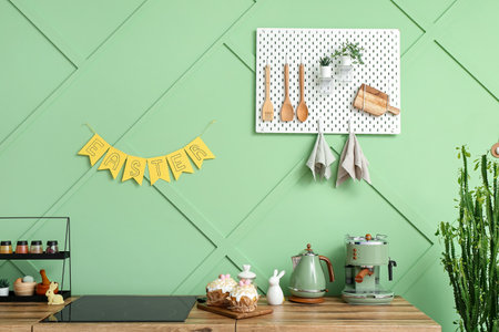 Easter cakes, bunnies, kettle and coffee machine on kitchen counterの写真素材