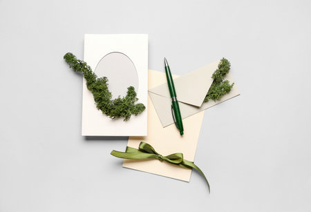 Composition with cards, envelope, pen and moss on white backgroundの写真素材
