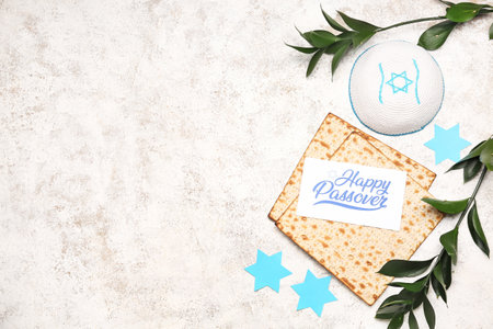 Composition with Jewish flatbread matza for Passover, kippah and plant branches on light backgroundの写真素材