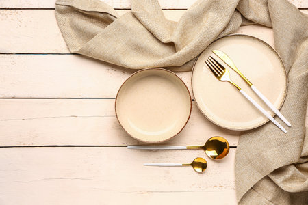 Plate, bowl and set of cutlery on white wooden backgroundの写真素材