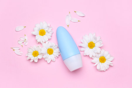 Composition with cosmetic product and fresh chamomile flowers on pink backgroundの写真素材