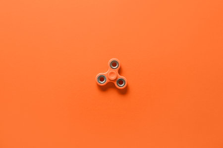 modern spinner on orange backgroundの写真素材