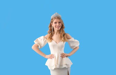Teenage girl in tiara and prom dress on blue backgroundの写真素材
