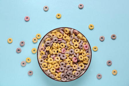Bowl of colorful cereal rings on blue backgroundの写真素材