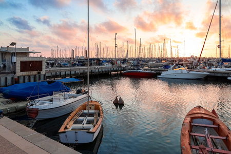 View of beautiful pier with yachts at sunset