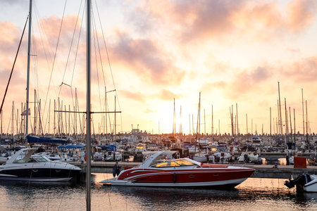 View of beautiful pier with yachts at sunsetの写真素材