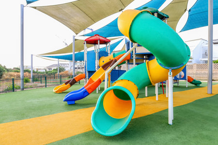 View of children's playground with slides in cityの写真素材