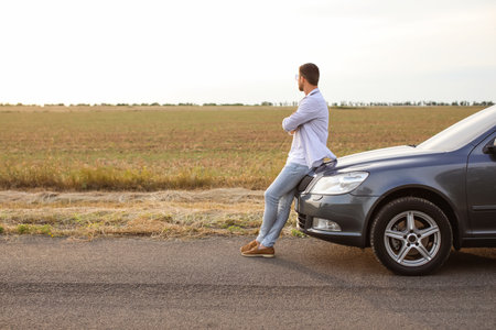 Handsome man near modern car outdoorsの写真素材