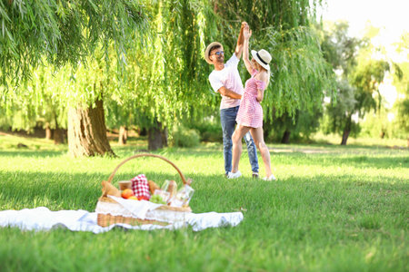 Happy young couple on picnic in parkの写真素材