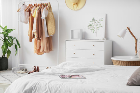 Interior of stylish bedroom with clothes rackの写真素材