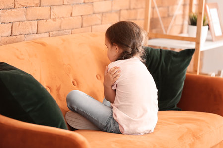 Sad little girl with autistic disorder at homeの写真素材