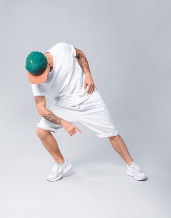 Male hip-hop dancer on gray background