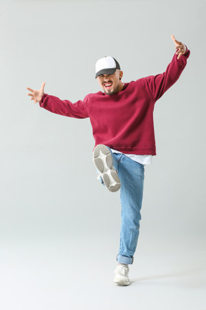 Male hip-hop dancer on gray backgroundの写真素材