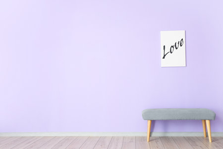 Cozy bench and picture near color wall in roomの写真素材