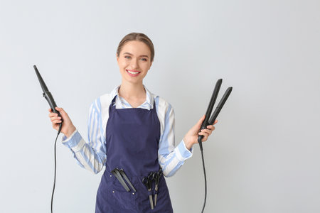 female hairdresser on light backgroundの写真素材