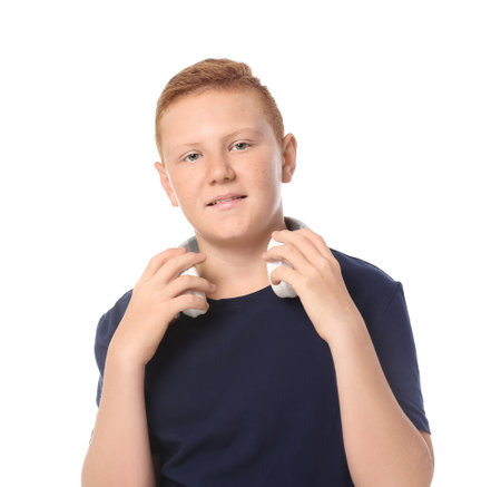 Teenage boy with headphones on white backgroundの写真素材