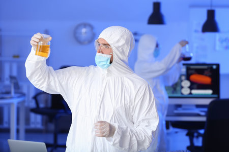 Scientist studying sample in laboratory