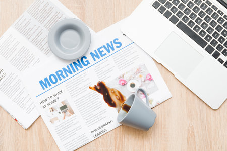 Cup and spilled coffee on wooden tableの写真素材