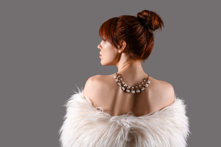 Beautiful redhead woman on gray backgroundの写真素材