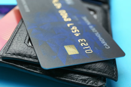 Credit card and wallet on color background, closeup