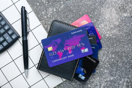 Wallet and credit cards and notebook on gray backgroundの写真素材