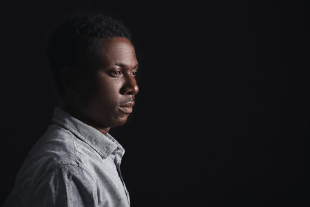 Sad African-American man on dark background. stop racismの写真素材