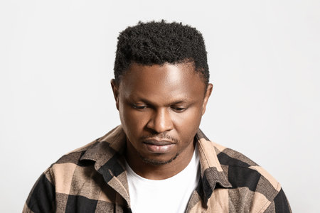 Sad African-American man on light background. stop racism