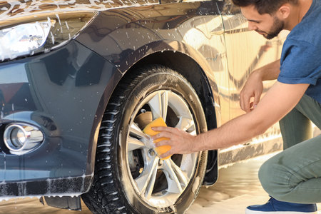 Man washing his car outdoorsの写真素材