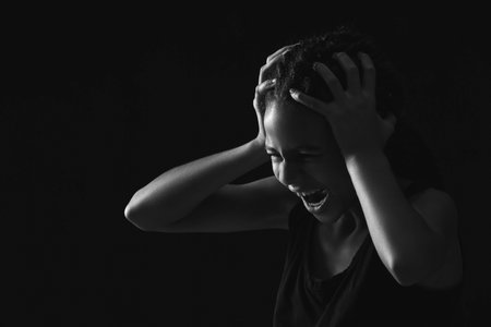 Stressed African-American girl on dark background. stop racismの写真素材