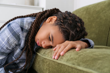 Sad African-American girl at home. stop racismの写真素材