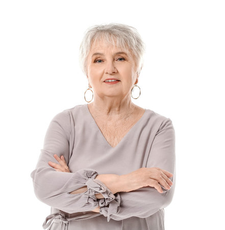 Stylish senior woman on white background