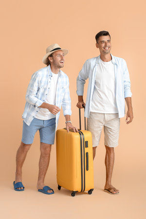 Couple of gay tourists on color backgroundの写真素材