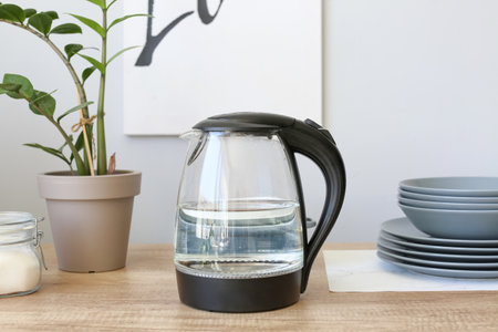 Modern electric kettle on kitchen tableの写真素材