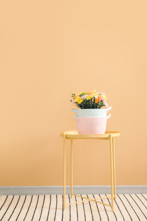 Wicker baskets with flowers on table in roomの写真素材