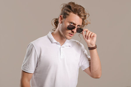 Handsome man with stylish hairdo on gray backgroundの写真素材