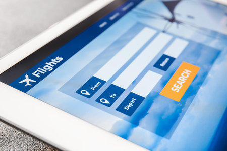 Open page of online booking service on screen of tablet computer, closeupの写真素材