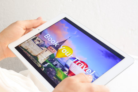 Woman with tablet computer booking tickets online, closeupの写真素材